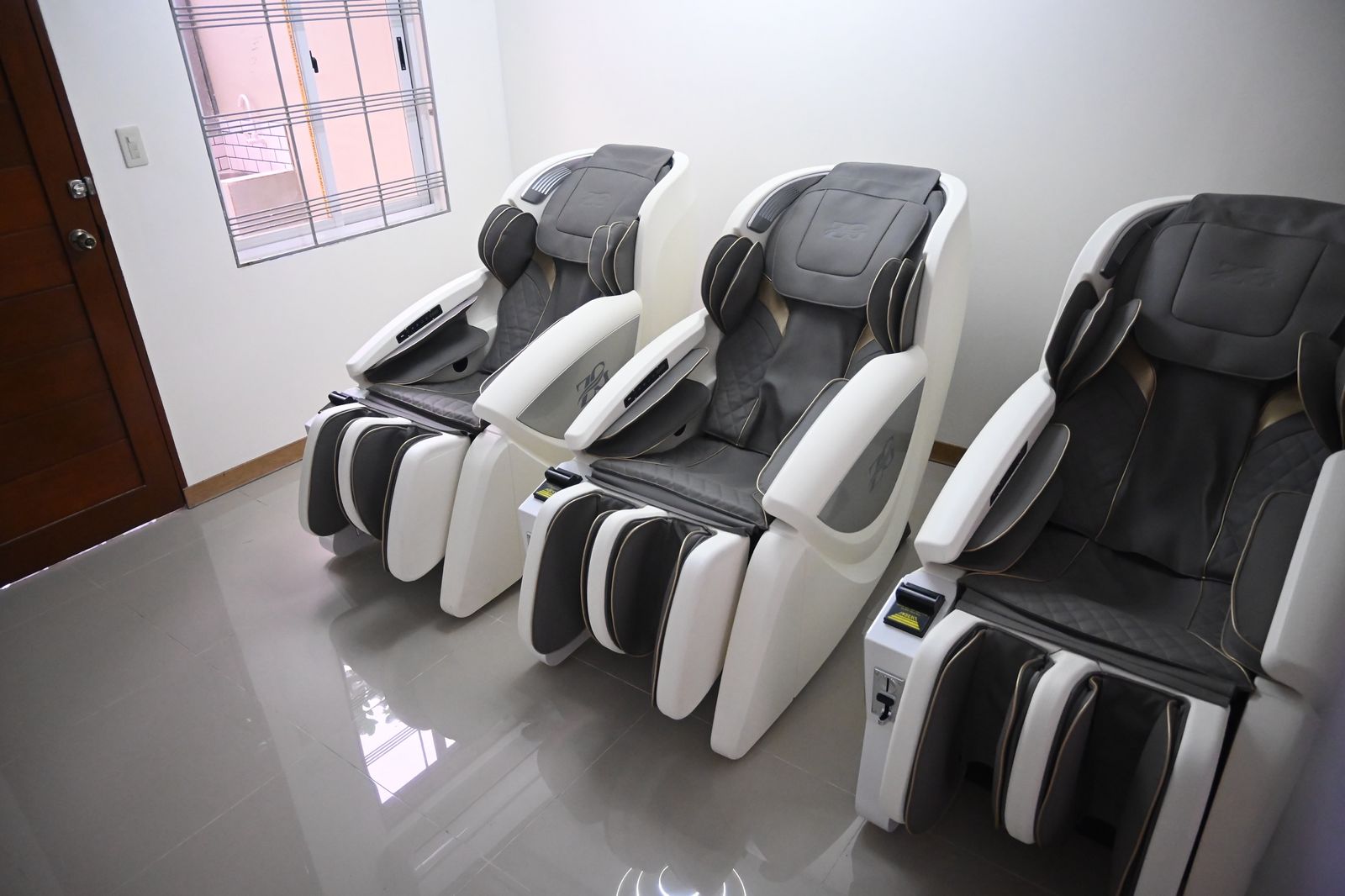 Three RelaxPod massage chairs set up in a room, ready for guests